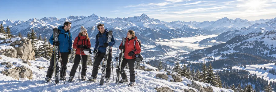Example: family together at a snowy mountain viewpoint.
